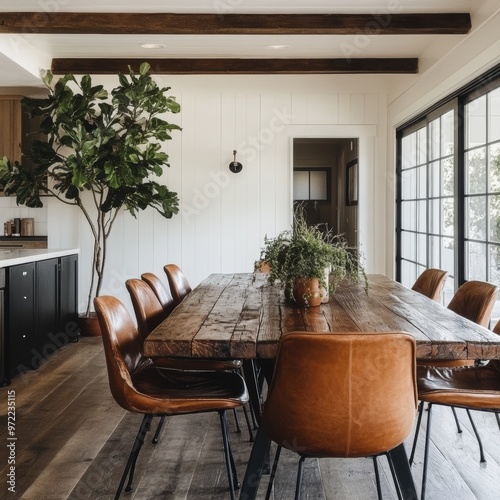 Modern Farmhouse Dining Room with Rustic Wood Table and Leather Chairs photo