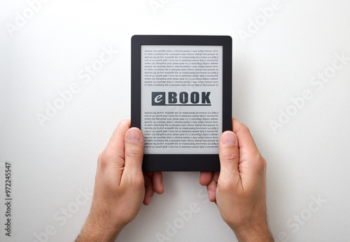 Fotografía Hands holding an ebook with text on white isolated table