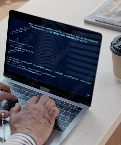 
The video shows a person typing code on a laptop, with lines of code being written and displayed on the screen. The fast-paced keystrokes suggest active programming, possibly in a coding environment  photo