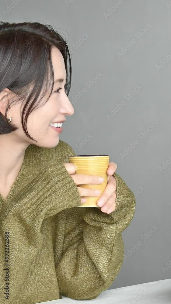 Vertical video of a smiling Japanese couple sitting on dining room chairs gazing at each other Autumn/Winter Vertical video of a smiling Japanese couple sitting on dining room chairs gazing at each other Autumn/Winter