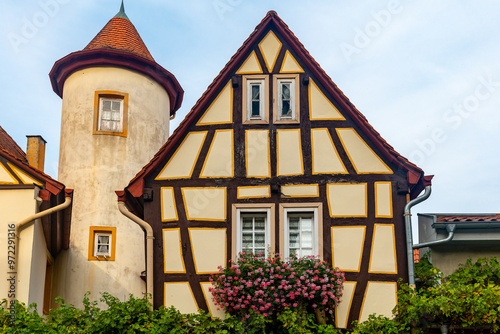 large building with a tower and a house with a flower box on the front