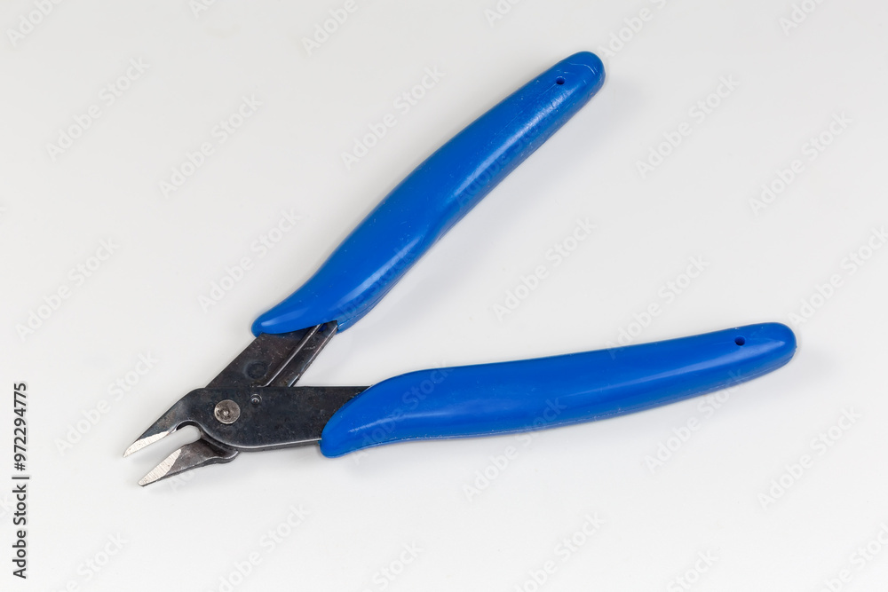 Diagonal nippers with blue insulated handles on a gray background Diagonal nippers with blue insulated handles on a gray background