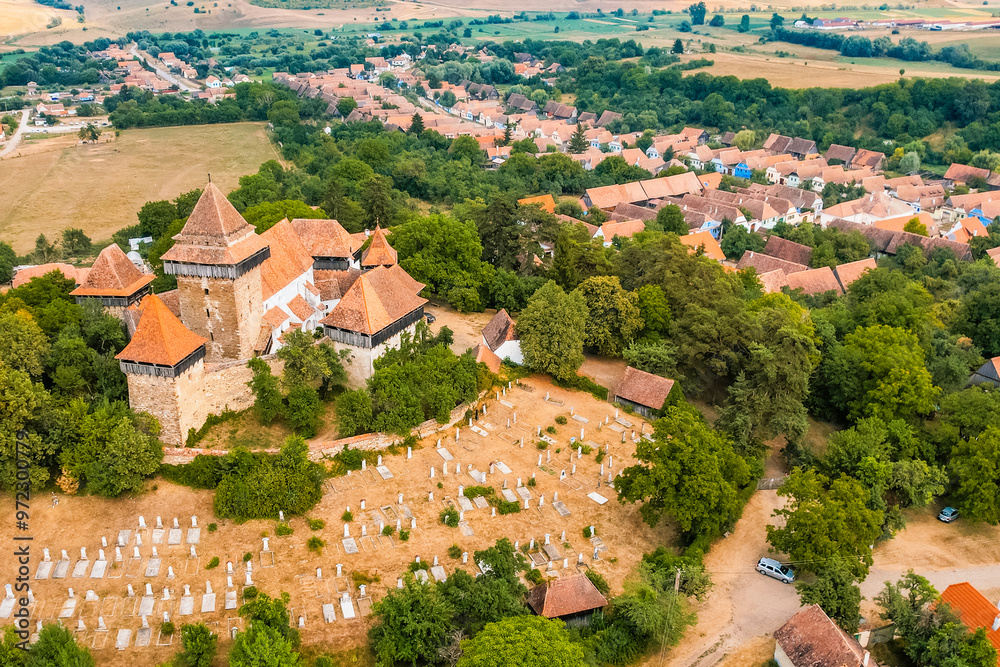Obraz premium Viscri, Romania. Blue old painted traditional house from village, Transylvania. The Viscri fortified church