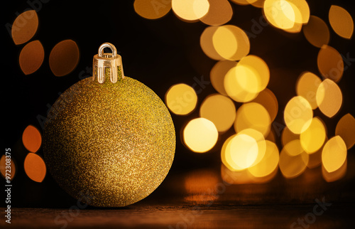 Golden Christmas ornaments on defocused lights background