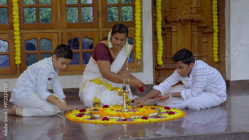 Athapookkalam decorating for onam festival in Kerala ,pookalam decorating Kerala traditional family for onam celebration photo