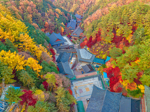 Danyang-gun, Chungcheongbuk-do, South Korea - October 31, 2020: Aerial and top angle view of Guinsa Temple surrounded by autumnal maple trees of Sobaeksan Mountain photo