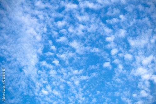 Cloudy blue sky background. Clouds in the summer sky. Natural wallpaper idea concep