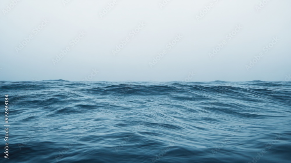 A minimalist image of ocean waves rolling softly toward the shore, with a wide-open horizon in the distance A minimalist image of ocean waves rolling softly toward the shore, with a wide-open horizon in the distance