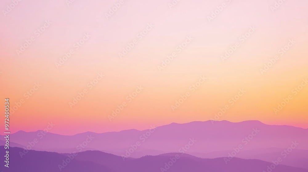 Obraz premium Layers of mountains create a stunning gradient effect under a colorful sunset sky, inviting viewers to explore nature's wonders in a peaceful atmosphere