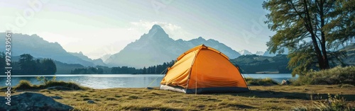 A tent is pitched up in front of a serene lake, set against a backdrop of majestic mountains in the distance