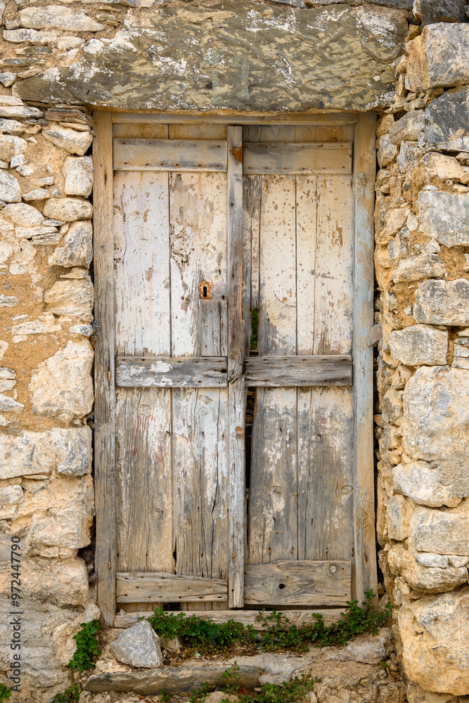 Old Greek wooden door in Tholaria village on Amorgos island, Greece Old Greek wooden door in Tholaria village on Amorgos island, Greece