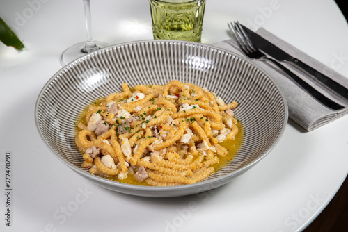 Passatelli with fish, typical Italian homemade pasta. Handmade Passatelli with fresh fish sauce photo