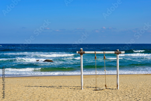 Gangneung-si, Gangwon-do, South Korea - November 28, 2020: Swing at Hyangho Beach of Jumunjin where is the Filming Site of BTS song YOU NERVER WALK ALONE
 photo