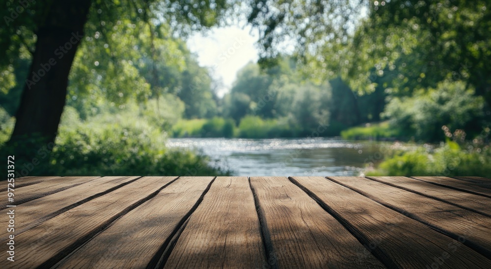 A serene river view with a wooden table in the foreground, ideal for relaxation or dining. A serene river view with a wooden table in the foreground, ideal for relaxation or dining.