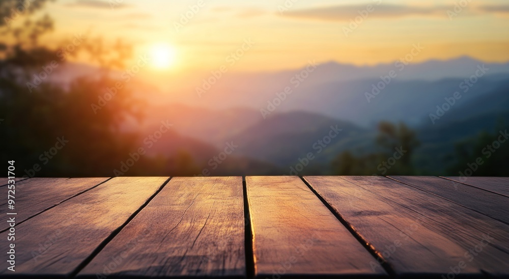 A serene sunset view over mountains, with a wooden table in the foreground. A serene sunset view over mountains, with a wooden table in the foreground.