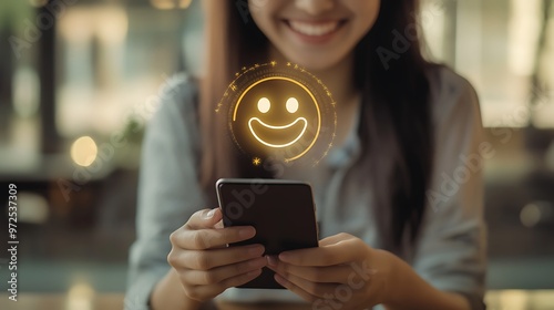 Wallpaper Mural A close-up of a woman's hands holding a smartphone with a glowing smiley face icon above it, symbolizing positive feedback or a good experience. Torontodigital.ca
