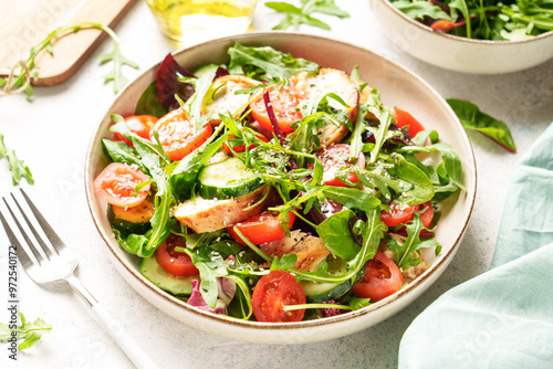 Green salad with baked chicken breast, fresh salad leaves and vegetables.