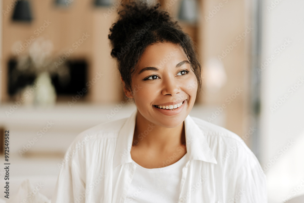 Young black woman smiling and relaxing at home Young black woman smiling and relaxing at home
