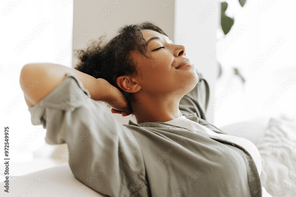 Young woman relaxing on comfortable sofa at home Young woman relaxing on comfortable sofa at home