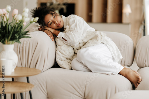 Young woman relaxing on comfortable sofa at home