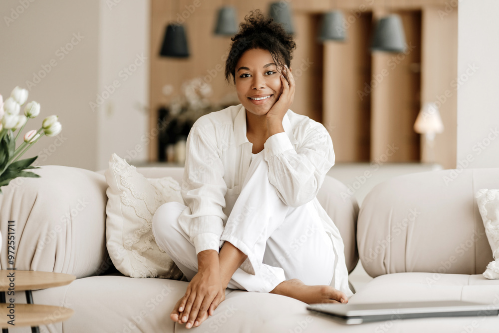 Young woman relaxing on comfortable sofa at home Young woman relaxing on comfortable sofa at home