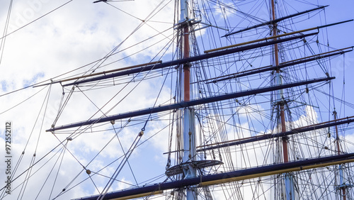 Shkots, halyards, braces on ship mast, blue sky and sea background, sailing. photo