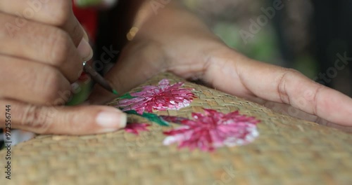 Hands of a Beautiful artist lady and artist painting together at a colorful table, surrounded by basket, brushes, acrylic colors tube and craft materials,Wicker handmade from krachut , Very Close up.