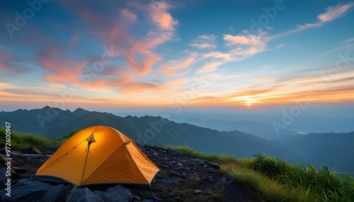 Summit campsite with tent against breathtaking mountain backdrop