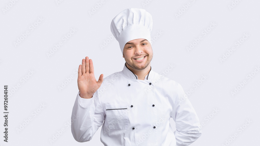Hello, I'm Chef. Professional Cook Man Waving Hand Smiling To Camera Standing Over White Studio Background. Panorama Hello, I'm Chef. Professional Cook Man Waving Hand Smiling To Camera Standing Over White Studio Background. Panorama