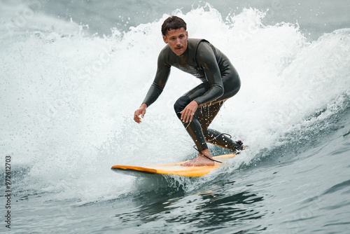 Canvas Print Surfers catching waves, waiting for a wave to come in the middle of the ocean