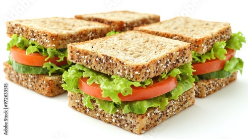 Stacked whole grain sandwiches filled with crisp lettuce and fresh tomato slices