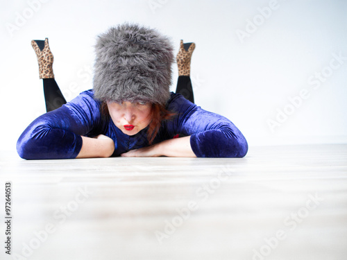 Funny glamour dressed sexy woman lying on the floor in a white flat, glamour image with copy space perfect for invitation