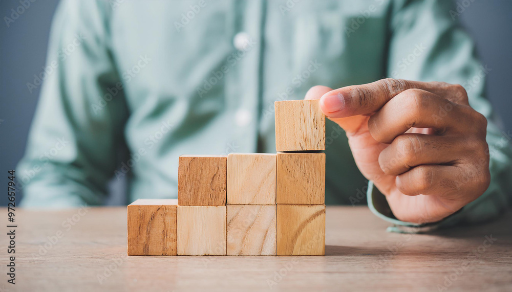 Wooden blocks symbolizing planning and development. Strategic steps for achieving business growth Wooden blocks symbolizing planning and development. Strategic steps for achieving business growth
