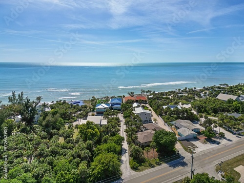 Aerial view of a coastal residential area with the clear blue ocean and sky. Florida, USA photo