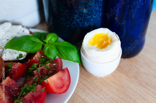 Healthy Breakfast tomato salad, muffins with cream cheese, coffee and hardboiled egg