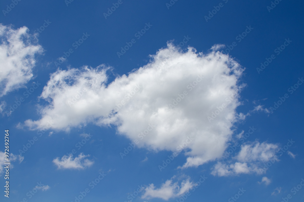 Panoramic view of white clouds against a bright blue sky Panoramic view of white clouds against a bright blue sky