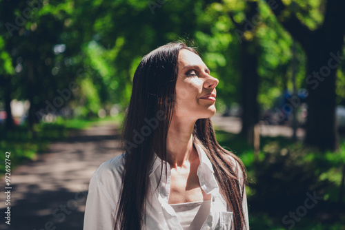 Photo of young cheerful woman closed eyes enjoy sun light wear white outfit walk park sunny summer weather outside