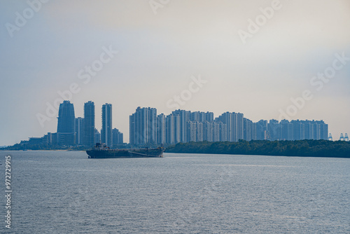 Tuas Second Link Bridge connecting Singapore and Johor, Malaysia. Buildings at Forest City and Singapore's port. View from the Straits of Johor. photo