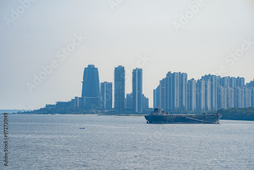 Tuas Second Link Bridge connecting Singapore and Johor, Malaysia. Buildings at Forest City and Singapore's port. View from the Straits of Johor. photo