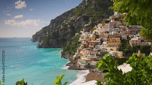 Wallpaper Mural Beautiful Positano village, Amalfi coast, Italy. Camera moves between green leaves, overlooking the beach with turquoise water, colorful houses and mountains in Positano village. Steadycam shot, 4K Torontodigital.ca