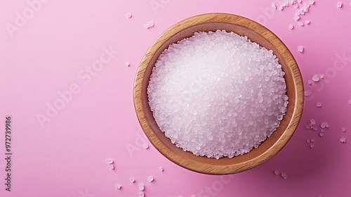 Natural sweetener in a wooden bowl on a pink background. Sugar substitute. Erythritol. photo