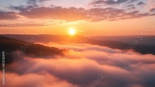 A breathtaking sunrise over a foggy valley, with the sun rising above the mist and the sky painted in soft pastel colors.