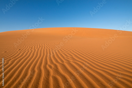 Wind-blown sand lines on a red sand dune in the Deadvlei desert of Namibia