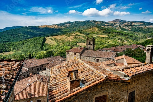 Panorama of the town of Santa Fiora Tuscany Italy, in the foreground the roofs of the houses in the background the characteristic surrounding Tuscan countryside photo