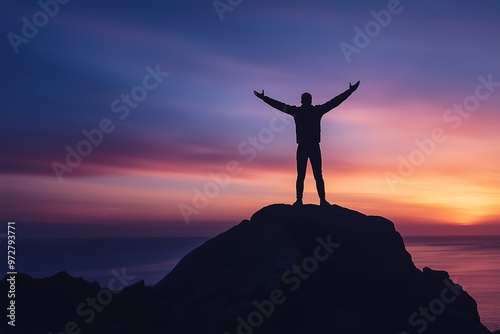 Silhouette of a person celebrating victory on a mountain peak at sunset