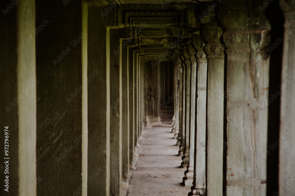 Fototapeta premium Exploring the serene corridors of Angkor Wat in Cambodia during a peaceful early morning