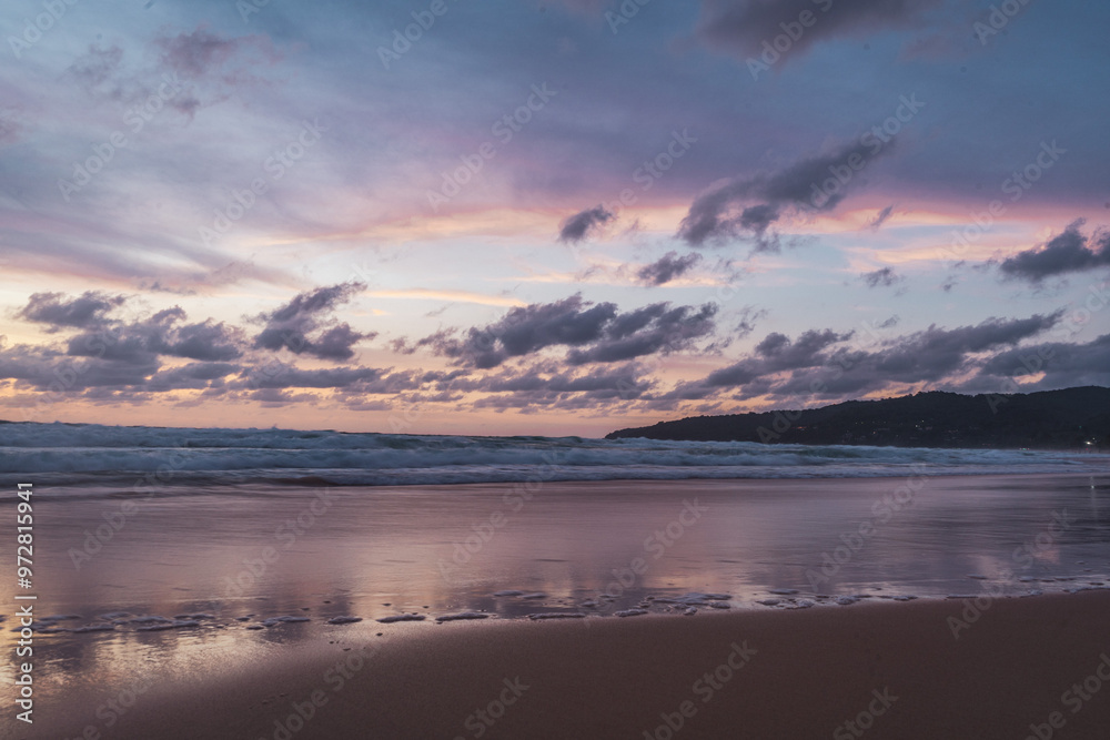 pink and orange sunset with clouds at karong beach in phuket pink and orange sunset with clouds at karong beach in phuket