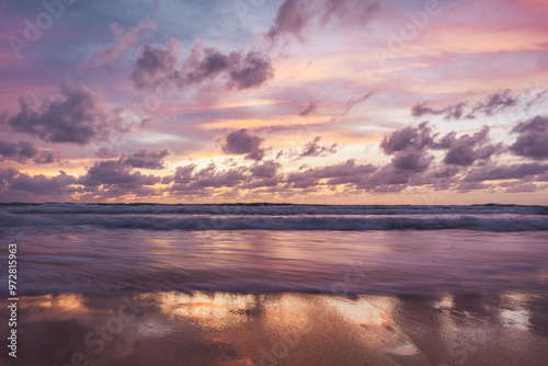 pink and orange sunset with clouds at karong beach in phuket