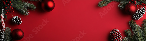 Festive Christmas background with red ornaments and green pine branches, perfect for holiday celebrations and seasonal designs.