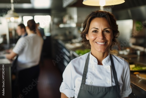 Portrait of a middle aged Hispanic female chef in kitchen